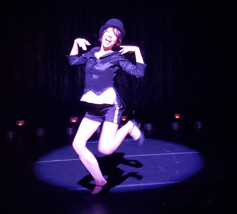 Dancer in bowler hat and tuxedo shorts