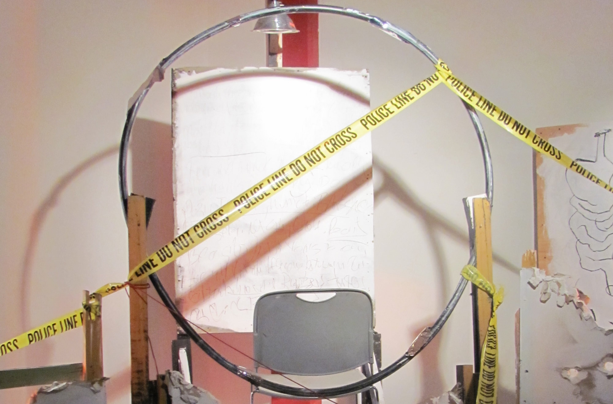 Image of a set with police tape crisscrossing the set