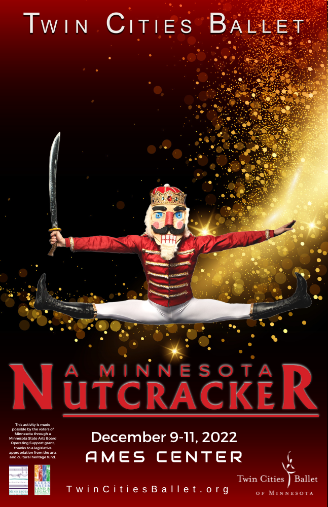 A dancer dressed as the Nutcracker performs a large center split jump